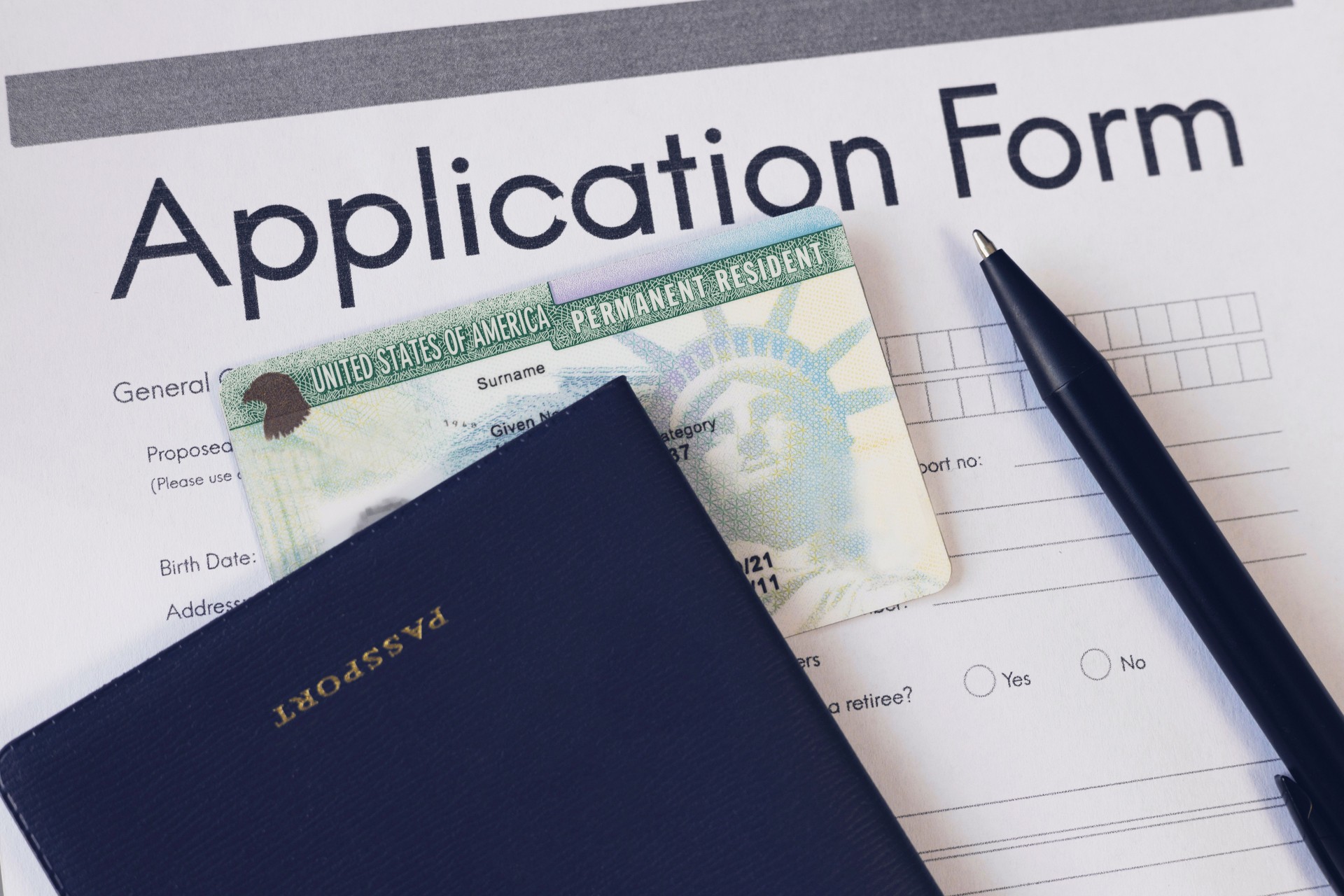 Green card application form and passport. Application to register permanent residence. Immigration concept