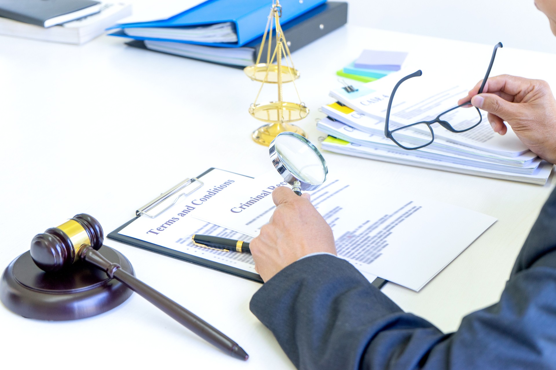 Lawyer or judge use magnifier glass look to the paper